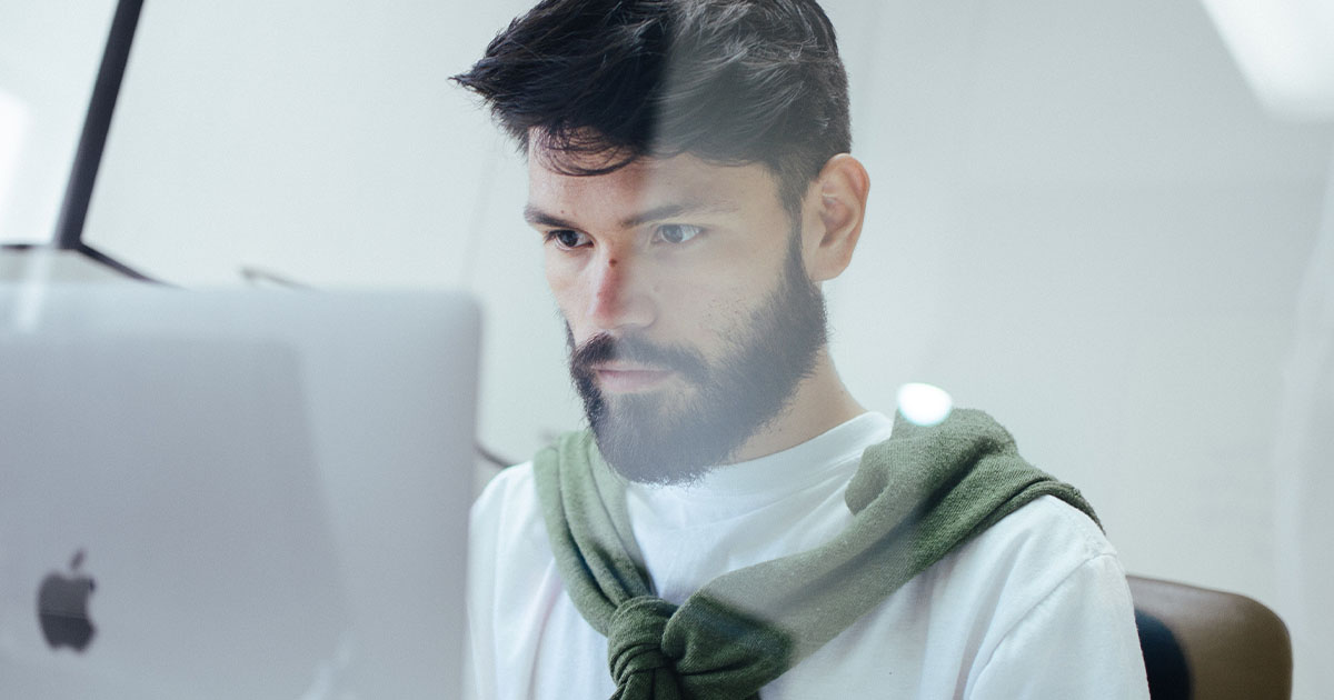 Man sitting at computer working tech job